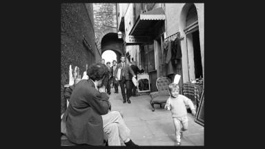 Man sitting outside furniture shop, Merchant's Arch, Temple Bar, Dublin