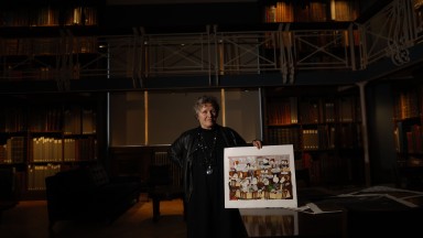 Annie West with artwork standing in the NLI's Art Room