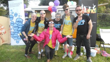 Group photo in front of a stand