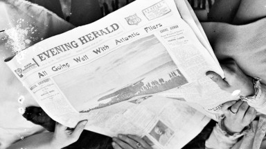 newspaper held by the two women