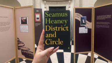 a copy of seamus heaney's poetry collection 'district and circle' in the exhibition entrance 