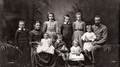Black and while photograph of a group of adults and children.