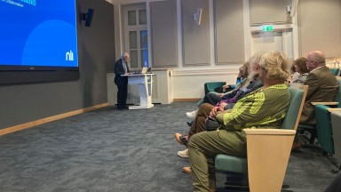 Man delivering speech to an audience