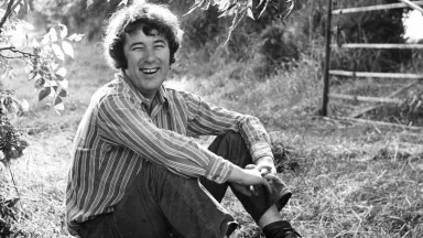 Seamus Heaney sitting outside in Wicklow