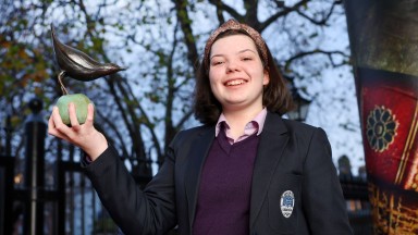 Anna Rose Nic Mhanais holding trophy on steps of the NLI