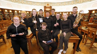 Group of musicians posing in the NLI's reading room
