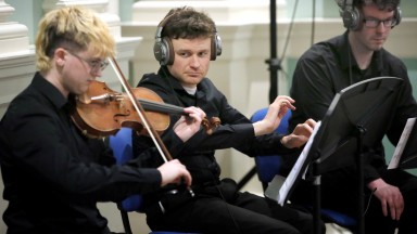 Close up on musicians performing 
