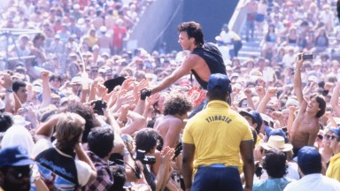 Rick Springfield reaching into the audience while on stage at JFK Stadium