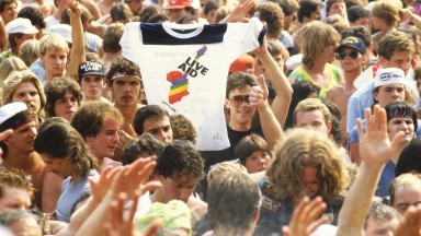 A Live Aid t-shirt being raised in the crowd at JFK Stadium