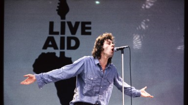 Bob Geldof performing at Wembley, with Live Aid logo in the background