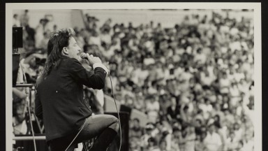 Bono on stage at Wembley, crowd in the background