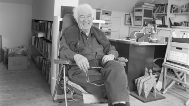 Seamus Heaney sitting in his chair in this office
