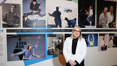 Woman in front of images from the exhibition