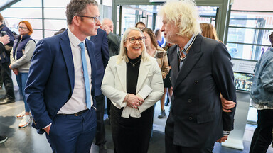 Two men and a woman in conversation