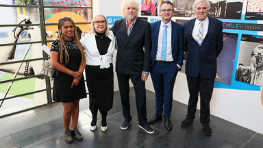 A group of adults facing camera, 2 women and 3 men