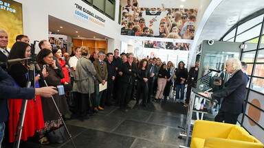 Man addressing crowd from a lectern