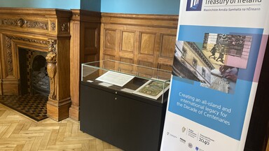 A glass display case with roll up banner
