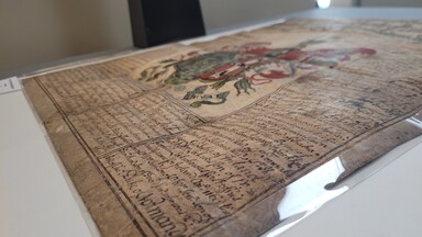 A detail of the polyester strips used to mount the parchment on the board.