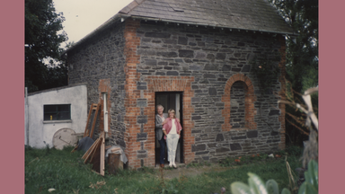 a photo of heaney and marie standing in the doorway of their house in Glanmore