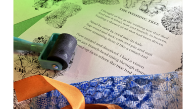 A close up of a print with roller and lace in the foreground