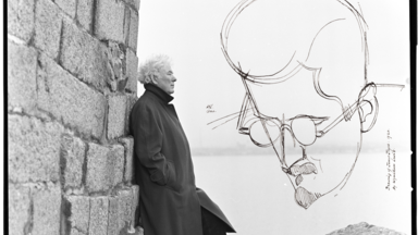 Heaney standing in front of the sea with sketch of joyce