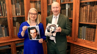 Dr Audrey Whitty and Liam Bluett with a collection of his photos