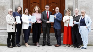 Group photo holding an annual report