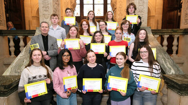 Group of young TY Reveal students holding certificates