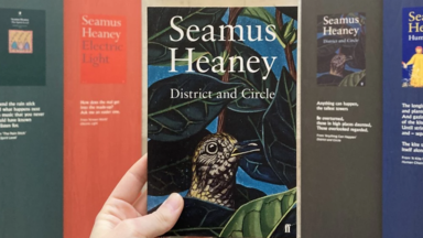The book district and circle held up in front of exhibition displays