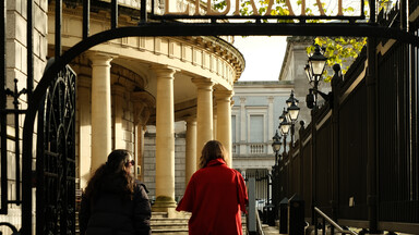 two women walking up to the library entrance