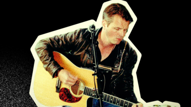 A musician sitting and playing an acoustic guitar, wearing a black leather jacket and jeans, with a microphone positioned in front of him. The image has a vintage, grainy appearance with a cream-coloured cut-out border against a black background.