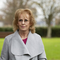 photo of rita anne higgins standing by a tree
