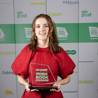 molly in red dress with book award