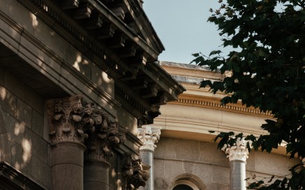 Exterior photograph of NLI's Main Library Building including tree and windows in shadow