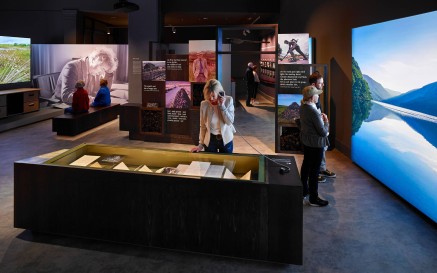 Interior of Seamus Heaney Listen Now Again exhibition with visitors looking at displays