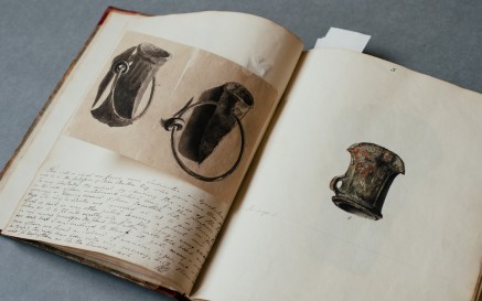 Image of an open book with drawings and writing