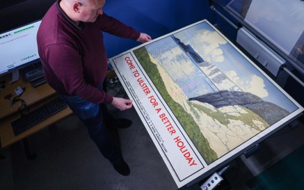 Image of staff photographing large scale print
