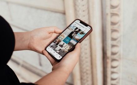 A woman browsing the NLI's Instagram feed on her iPhone