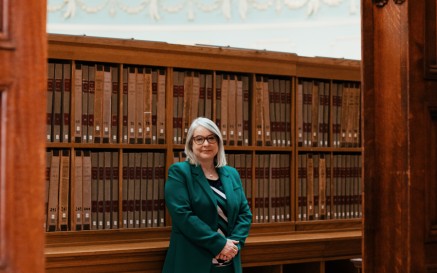 Image of Audrey Whitty under arch in reading room