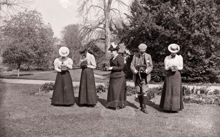 Women and men holding box cameras