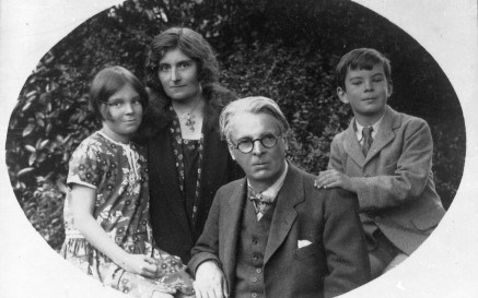 Black and white photograph of WB Yeats and his young family. From left to right , is his daughter Anne, his wife Georgie, WB Yeats and his son Michael.