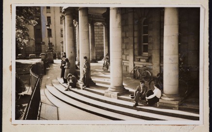 Men and women sitting on the steps of the NLI.
