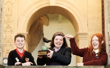A picture of the three category winners of Poetry Aloud holding the winning trophy.