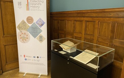 A glass display case with roll up banner