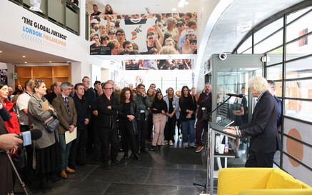 Man speaking from a lectern to a group of people