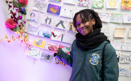 photo of young girl pointing to postcards