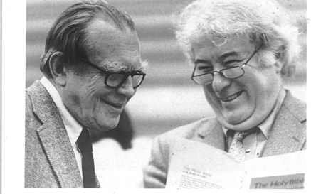 A black-and-white photograph of poets Czesław Miłosz and Seamus Heaney smiling together in conversation.