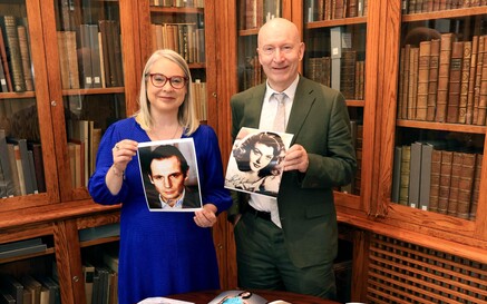 Dr Audrey Whitty and Liam Bluett with a collection of his photos