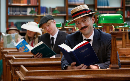 Three people reading Ulysses inside the NLI's reading room