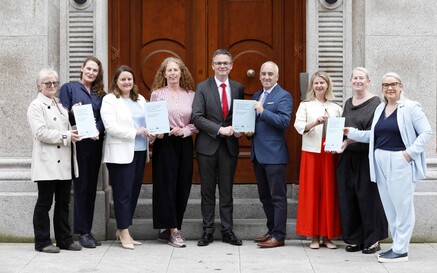 Group photo holding an annual report